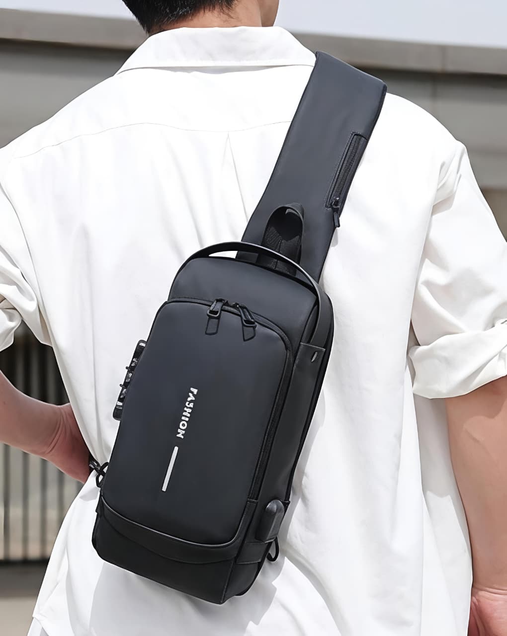 Person wearing a black sling bag with a visible brand logo.